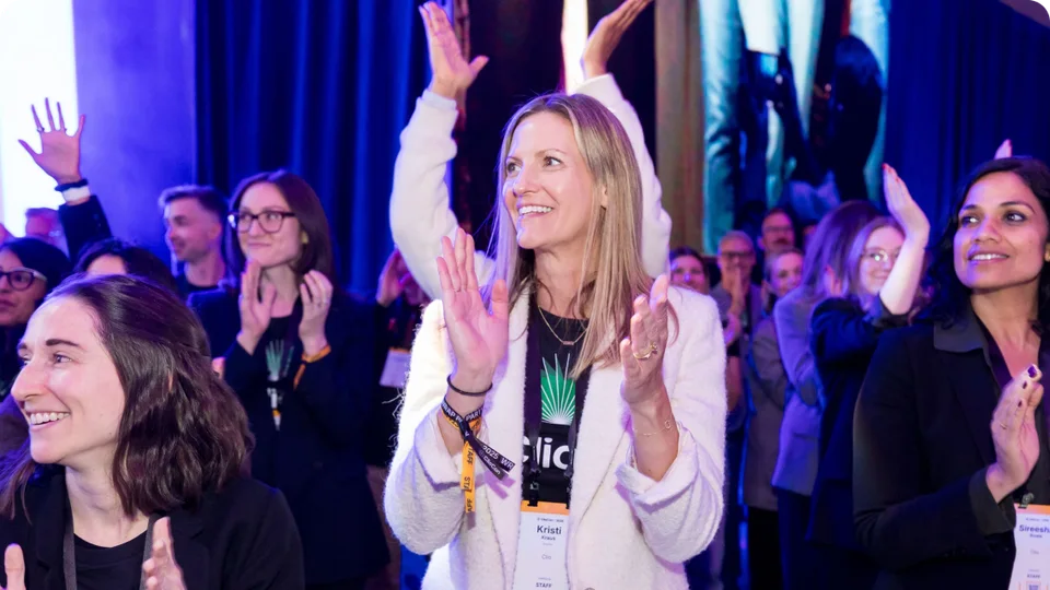 ClioCon attendees applauding during a conference session