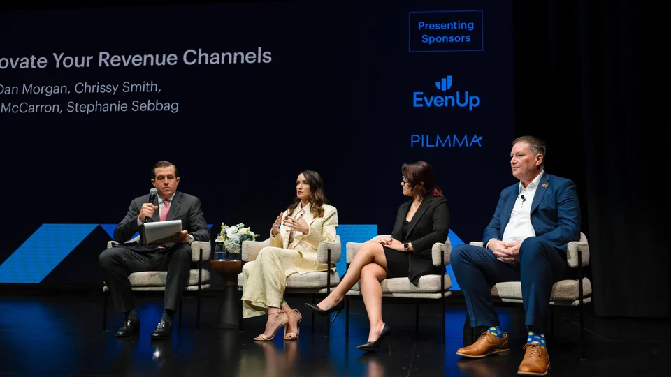 Panelists speaking at a RevCon event