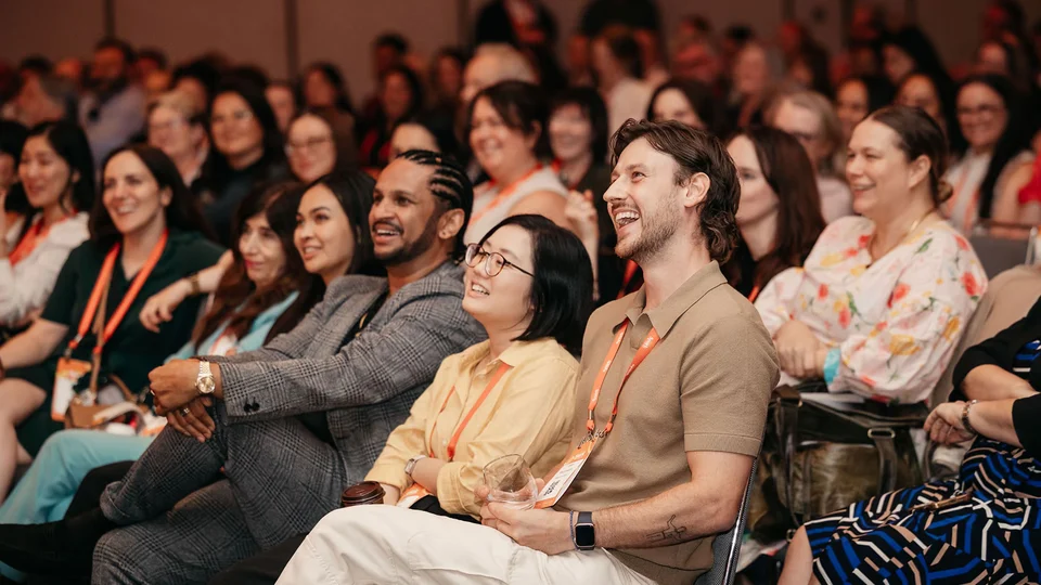 Audience smiling at a Smokeball conference